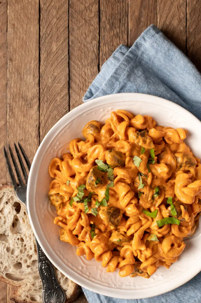 creamy roasted red pepper pasta in white bowl