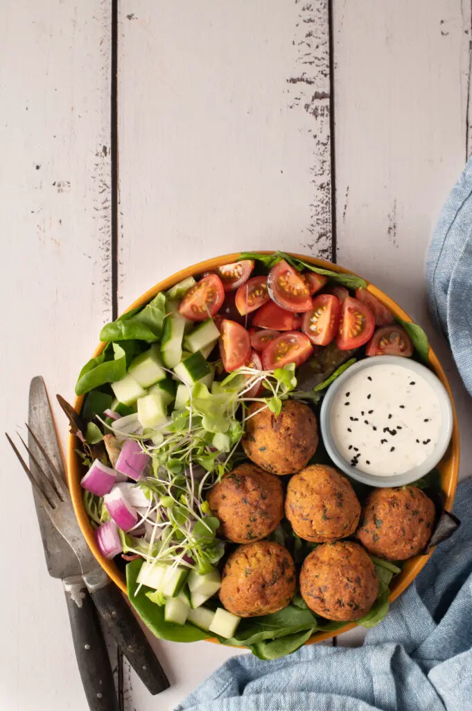 falafel plate with tomatoes, cucumber and greens