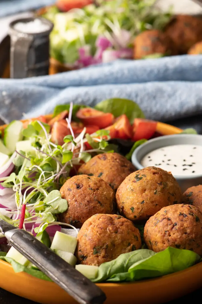 falafel plate with tomatoes, cucumber and greens