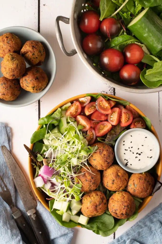 falafel plate with tomatoes, cucumber and greens