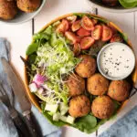 falafel plate with tomatoes, cucumber and greens
