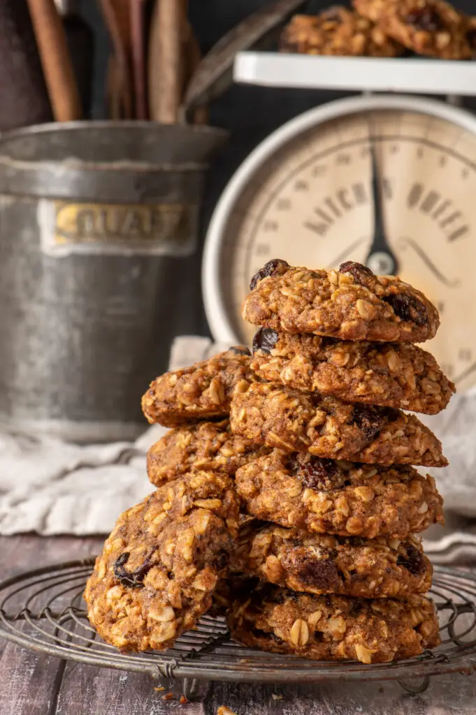 vegan oatmeal raisin cookies on cooling rack with kitchen scale in background