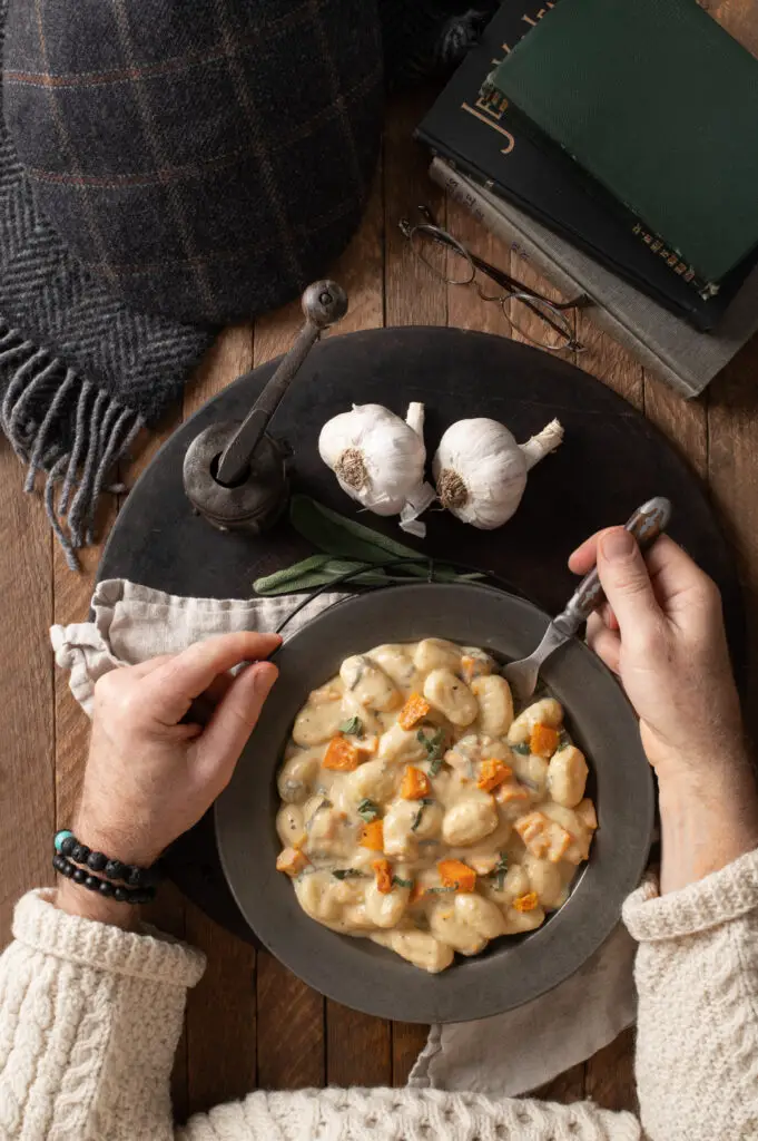 creamy butternut squash gnocchi on pewter plate